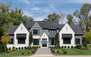 A beautiful white stone with dark gray and black accents home built by Legend Homes in Hardeman Springs